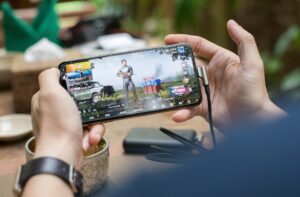 Mobile gamer practising a battle royale game on a smartphone